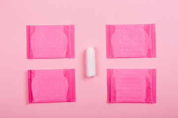 Daily sanitary tampon and pads for special critical days on pink background. Copy space. Secrets of...