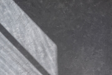Aesthetic geometric sunlight shadow on gray concrete textured wall, empty template for home room...