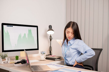 Businesswoman asia is sitting at workplace and feeling muscle aches from hard work. © nBhutinat