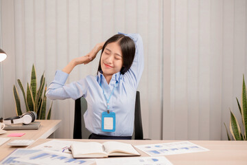 Businesswomen beautiful young asia is stretching her arms and feeling relax after hard work. © nBhutinat