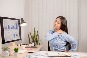 Businesswoman asia is sitting at workplace and feeling muscle aches from hard work. © nBhutinat