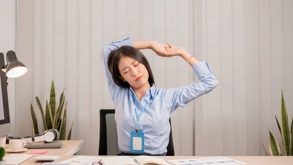Businesswomen beautiful young asia is stretching her arms and feeling relax after hard work. © nBhutinat