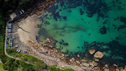 Aerial of a hidden NSW beach with boat on wood boat ramp