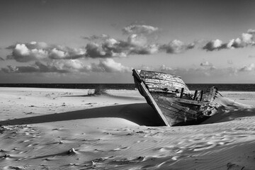 Ruined wooden boat on the empty beach in Bolonia, Andalusia, Spa