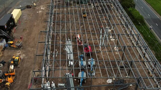Aerial view looking down at Aldi grocery store building site foundation steel framework and construction equipment