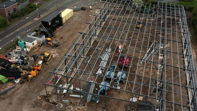 Aerial view overlooking Aldi grocery store building site foundation steel framework and construction equipment