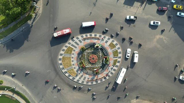 Static drone footage above a roundabout in Dalat city, south Vietnam showing the traffic in the center. 