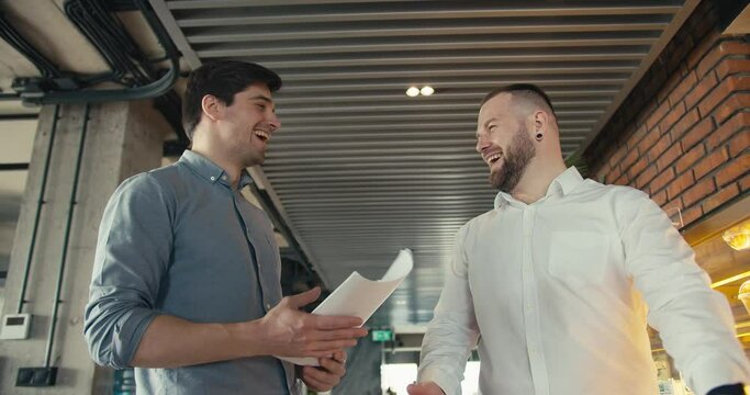 Celebrating Success: Two Office Colleagues Return from a Successful Conference with Joy and Triumph