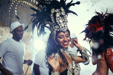 Festival, carnival dancer and woman smile with music and social celebration in Brazil. Mardi gras,...