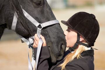 Horse kiss, trainer and woman on equestrian training and competition ground with a pet. Outdoor,...