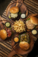 many different gourmet burgers selection on wood table