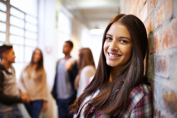 Education, happy and portrait of woman in college hallway for studying, learning and scholarship. Future, happy and knowledge with student leaning against wall for university, relax and campus