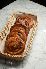 Baked pain aux raisins. Puff pastry bun with raisin