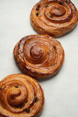 Baked pain aux raisins. Puff pastry bun with raisin