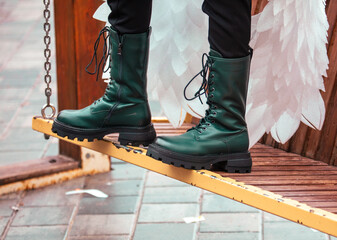Women's boots on a park bench