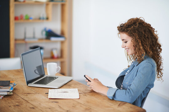 Happy woman, business student and texting on smartphone in creative startup, designer agency or desk. Young office intern typing on cellphone, online app or reading notification on mobile technology