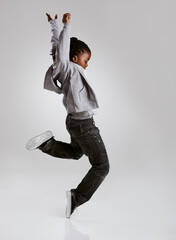 Talent, hip hop and young boy dancer dancing isolated in a white studio background in a pose feeling excited. African, urban and kid or child with energy and skill ready for breakdance performance