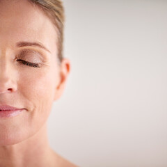 Beauty, mockup and half face with a woman in studio on a gray background for cosmetic skincare...