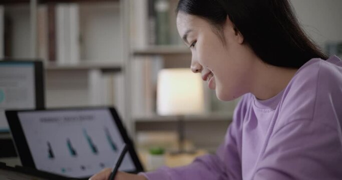Footage of young Asian woman, freelance data scientist work remotely at home coding programming on Big data mining, AI data engineering, Female writes notes on tablet. IT Technician. Telework concept.