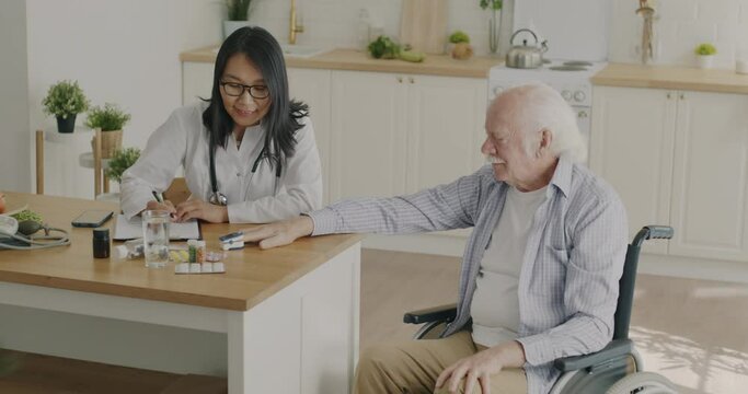 Nurse checking oxygen saturation with sensor examining patient at home and writing medical records. Healthcare equipment and domestic treatment concept.