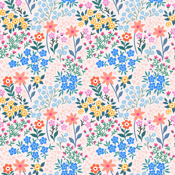 Seamless pattern. Vector flower design with cute wildflowers. Romantic abstract floral pattern on pale pink background. Illustrations of spring nature with red, blue and pink flowers.