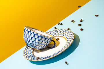 An abstract, bold and graphic photograph of a beautiful coffee cup and plate that appear to be...