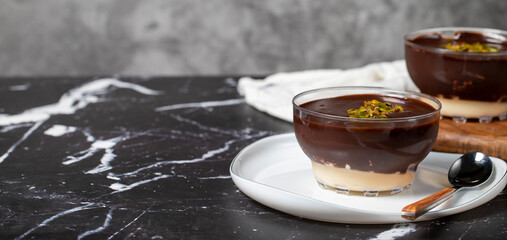 Chocolate supangle dessert. Cream and chocolate pudding or supangle dessert on dark background. Copy space. Empty space for text