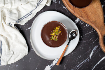 Chocolate supangle dessert. Cream and chocolate pudding or supangle dessert on dark background. Top...