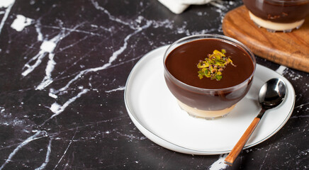 Chocolate supangle dessert. Cream and chocolate pudding or supangle dessert on dark background. Copy space. Empty space for text