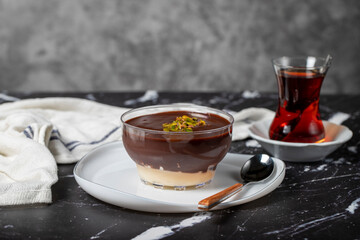 Chocolate supangle dessert. Cream and chocolate pudding or supangle dessert on dark background