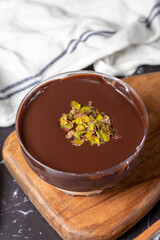 Chocolate supangle dessert. Cream and chocolate pudding or supangle dessert on dark background. Close up