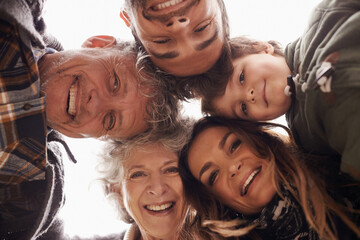 Obraz premium Faces, smile and below portrait of happy family together on outdoor vacation or holiday feeling excited. Grandparents, happiness and parents in a circle with child or kid for love and care