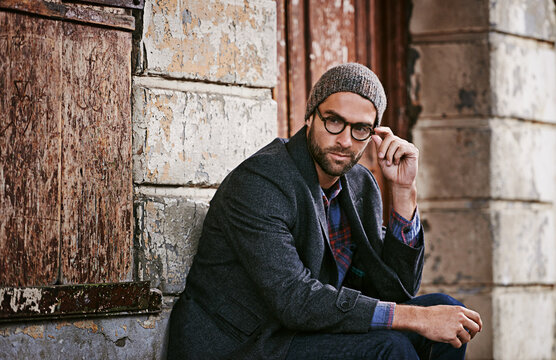 Thinking, fashion and man outdoor, winter and relax with trendy clothes, eyewear and thoughtful. Male person, model or guy with glasses, wonder or ideas with stylish outfit, relax or ponder in a city