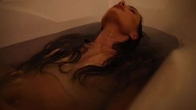 Young woman relaxing in the bathtub