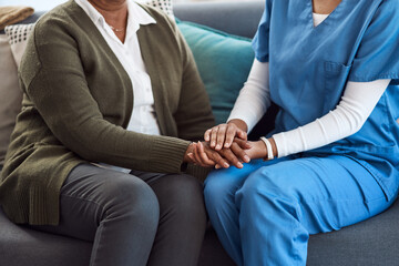 Im always here for you. an unrecognizable nurse and a senior patient holding hands in comfort.