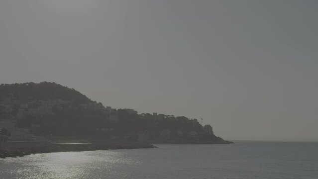Static shot of the coastline in Cannes France on a sunny day with the sea and a clear sky LOG