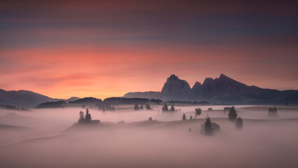 Naklejka na ściany i meble Dolomites mountain valley at beautifull misty foggy dawn