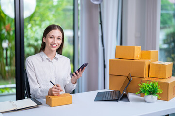 Startup, delivery and shipping in boxes for online shopping business. Businesswoman packing products from online business in a box to ship to clients and buyers.business woman working in the office