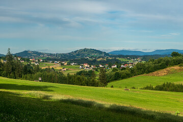 Obraz premium Jaworzynka village with hills on the background in Beskid mountains in Poland