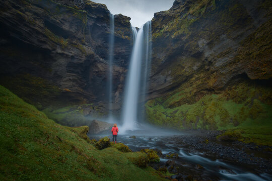 Women in hidden Kvernufoss waterfall at south Iceland