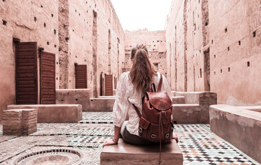 Woman tourist visiting old ruin palace ( Palais El Badi) in Marrakech, Morocco