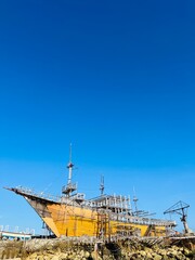 Abandoned broken ship-wreck beached on rocky sea shore