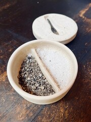 Sea salt flakes and freshly ground black pepper. Top down with wood textured slate background