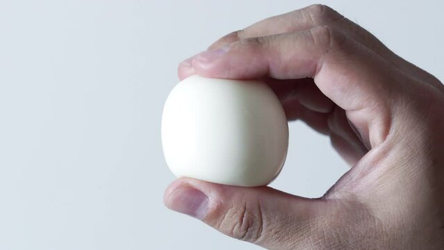 Kneading a boiled egg with a hand, Skin care or make up image, Protein or health, Nobody
