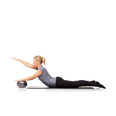 Such a variety of exercises. A young woman using an exercise ball while lying down - isolated.