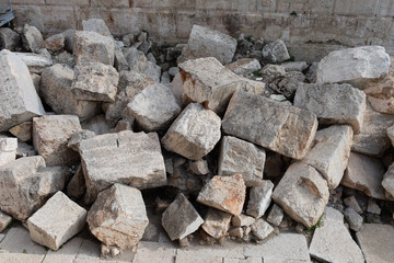 Pile of large stones at the base of the Western Wall in Jerusalem, beneath Robinson's Arch, believed to be ruins of the Second Jewish Temple, destroyed by the Romans in 70 AD.  - obrazy, fototapety, plakaty