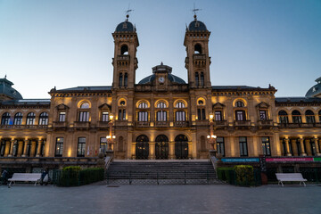 San Sebastian, SPAIN - July 09 2022 Streets of San Sebastian - Donostia. View of Town Hall building at night luminated. Famous travel destination in north of Spain. 