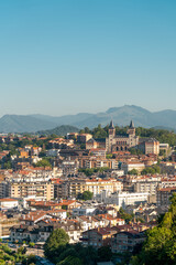 Fototapeta premium San Sebastian, SPAIN - July 09 2022: High angle view of San Sebastian - Donostia City. Travel destination in north of Spain in Vesque Country. View of city center. In background hills and mountains. 