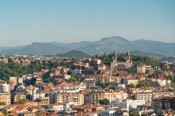 Fototapeta na wymiar San Sebastian, SPAIN - July 09 2022: High angle view of San Sebastian - Donostia City. Travel destination in north of Spain in Vesque Country. View of city center. In background hills and mountains.