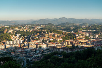 Fototapeta na wymiar San Sebastian, SPAIN - July 09 2022: High angle view of San Sebastian - Donostia City. Travel destination in north of Spain in Vesque Country. View of city center. In background hills and mountains.